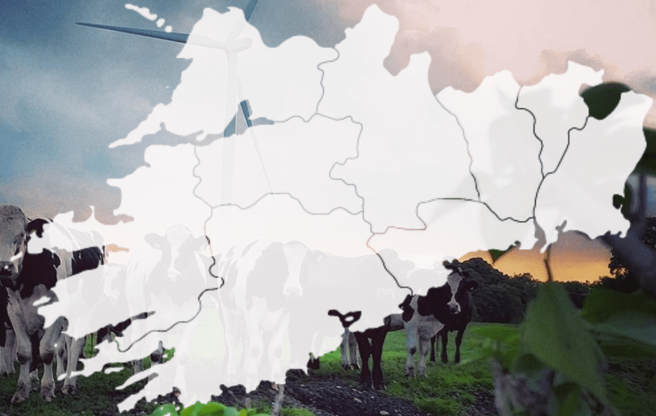 map of southern region of ireland overlayed a photo of cows in a field with a wind turbine